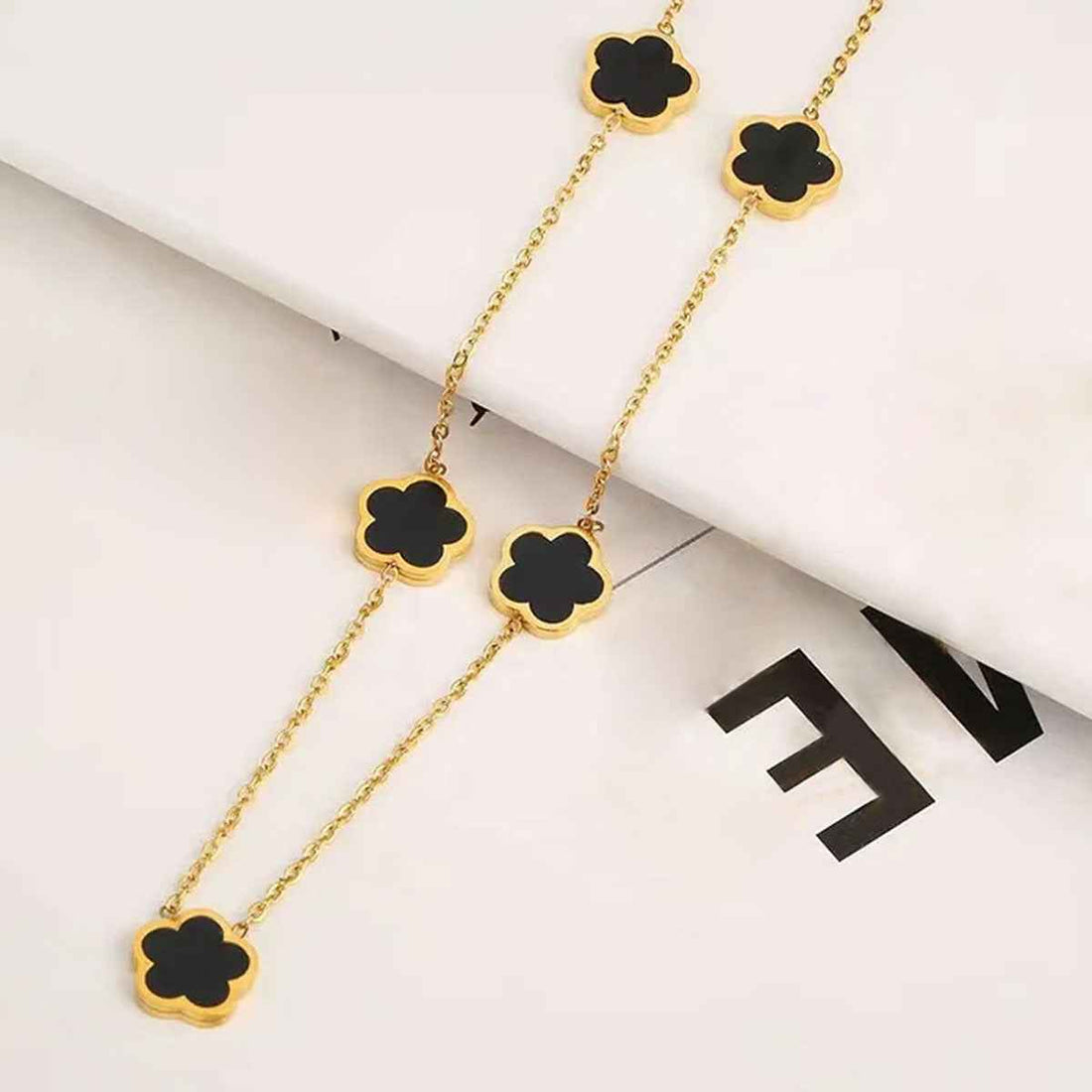 (Copy) Stainless Steel Parthenocissus Grass Electroplated Shell 18K Gold Plated Simple Style O-Shaped Chain necklace. In black and white.
